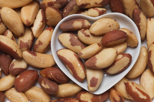 Brazil nut, healthy food ingredient in heart shaped tray