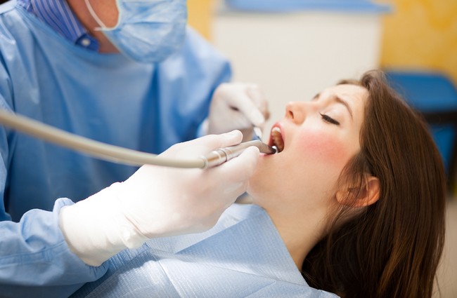 Dentist doing a dental treatment on a female patient