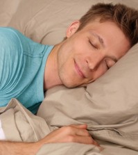 Young man peacefully sleeping in bed