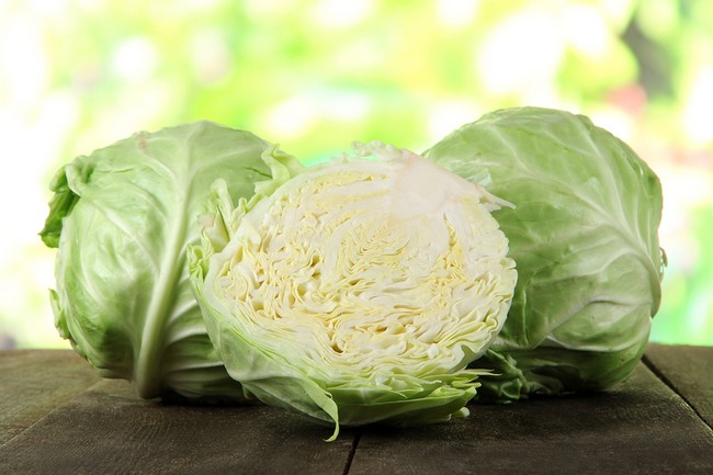 Cabbage on wooden table on nature background