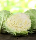 Cabbage on wooden table on nature background