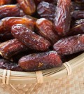 Dates fruit. Pile of fresh dried date fruits in a basket.