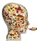 a glass head filled with many tablets. photo icon for drugs