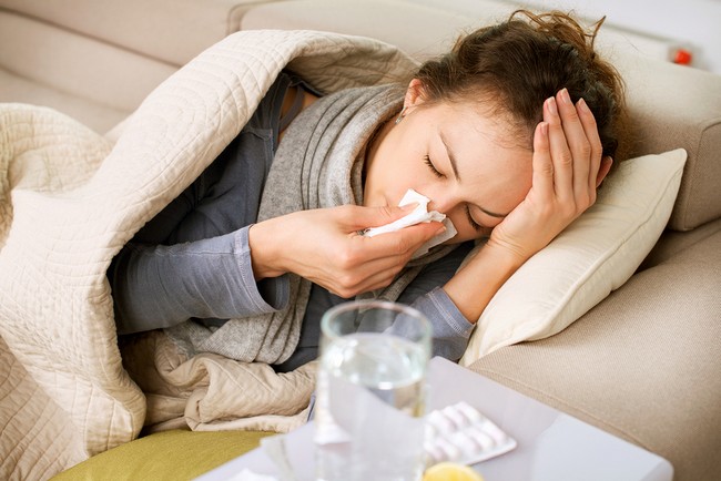 Sick Woman.Flu.Woman Caught Cold. Sneezing into Tissue. Headache