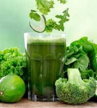 Healthy green vegetable juice on wooden table