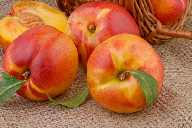 peach or nectarine on burlap background