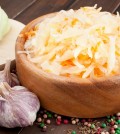 Sauerkraut With Carrot In Wooden Bowl, Garlic, Spices, Cabbage O