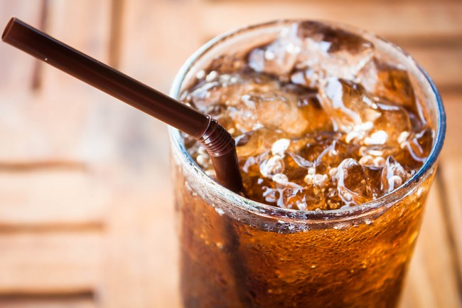 Cold glass with cola and ice cubes