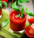 Tomato Juice and Fresh Tomatoes with Basil on a Wooden Table