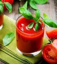 Tomato Juice and Fresh Tomatoes with Basil on a Wooden Table