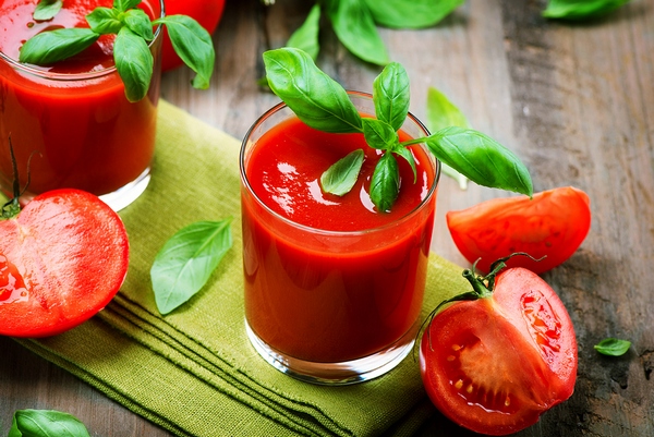 Tomato Juice and Fresh Tomatoes with Basil on a Wooden Table