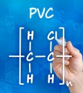 Hand with pen drawing the chemical formula of PVC