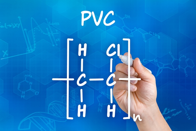 Hand with pen drawing the chemical formula of PVC