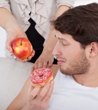 Man Choosing Donut Instead Of Apple