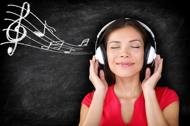 Music - woman wearing headphones listening to music with music n