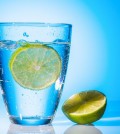 a glass of fresh drinking water and a lime. mineral water