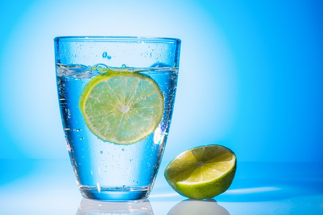 a glass of fresh drinking water and a lime. mineral water