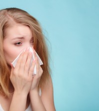 Flu Allergy. Sick Girl Sneezing In Tissue. Health