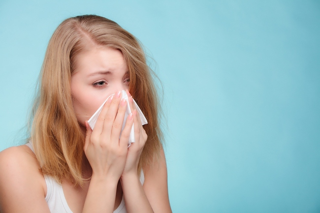 Flu Allergy. Sick Girl Sneezing In Tissue. Health