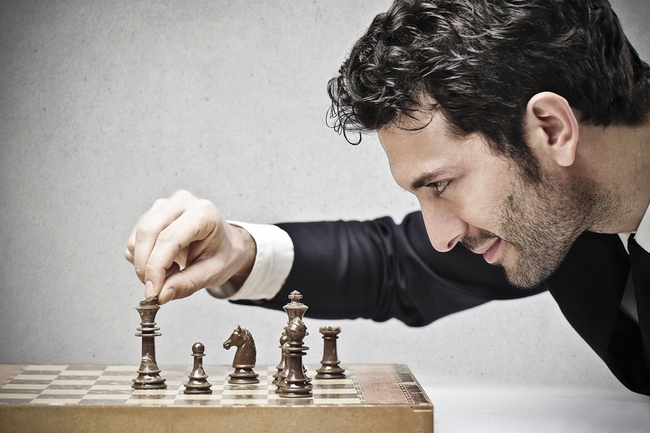 young business man playing chess