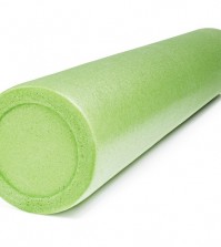 A green foam roller isolated on white with natural shadows. Foam