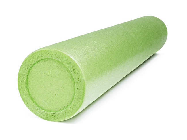 A green foam roller isolated on white with natural shadows. Foam