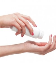 Beautiful female hands with the talcum powder isolated on white