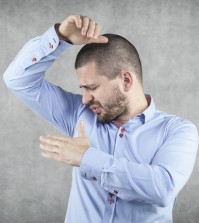 Businessman Smelling His Armpits