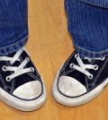 pigeon-toed teen in sneakers