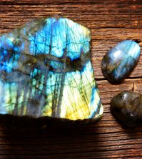 Polished labradorite crystals on wooden board