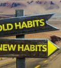 Old Habits - New Habits signpost in a desert road background