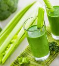 Healthy green smoothie on table celery and broccoli juice mix