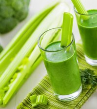 Healthy green smoothie on table celery and broccoli juice mix