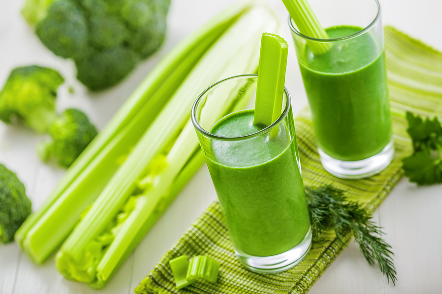 Healthy green smoothie on table celery and broccoli juice mix